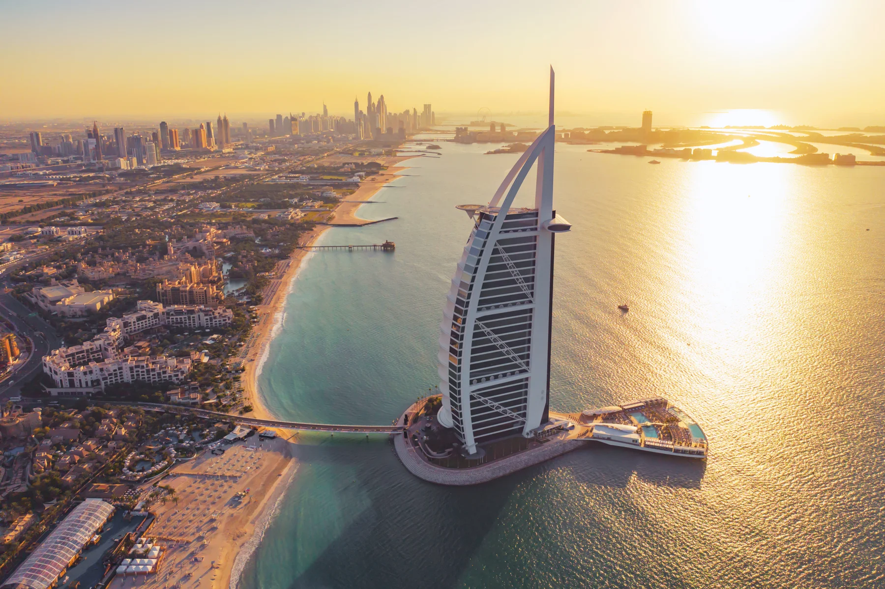 Golden light over Dubai's coastline and the Burj Al Arab